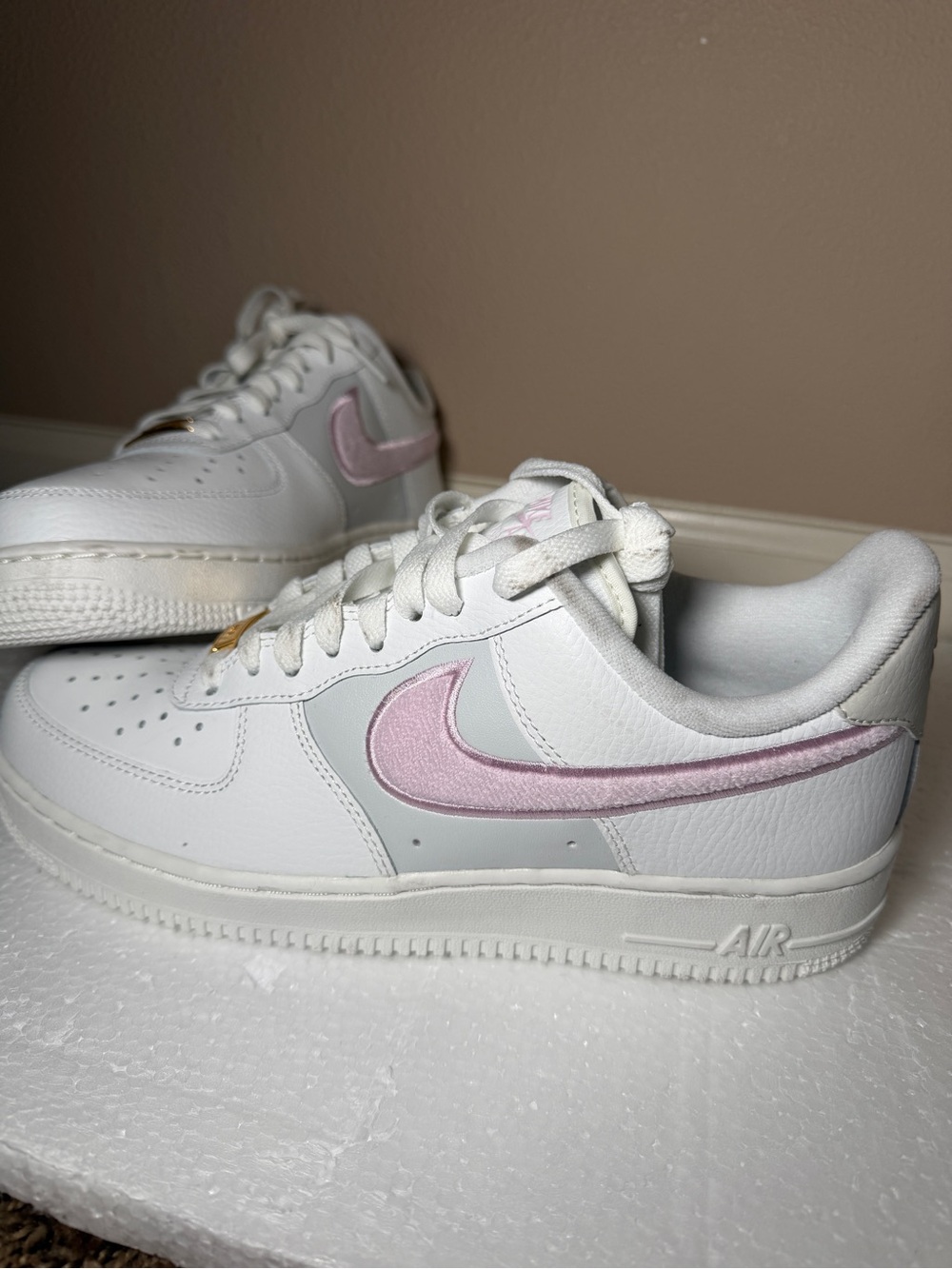 Nike White Low-Top Sneakers with Light Pink Swoosh